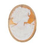 A cameo brooch. The oval-shape cameo carved to depict a lady in profile, to the plain surround.