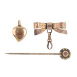 Three items of early 20th century gold jewellery. To include a stickpin, the circular head with ruby