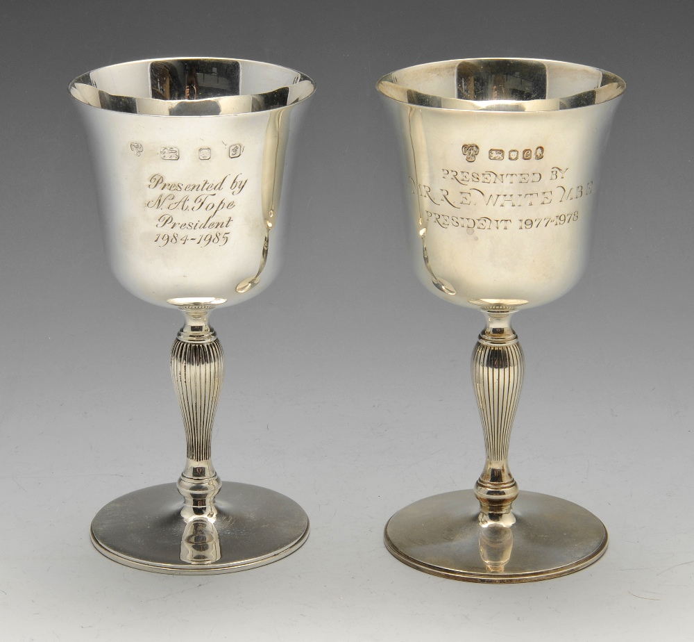 A matched pair of modern silver goblets, with presentation engraving and coat of arms above a ribbed