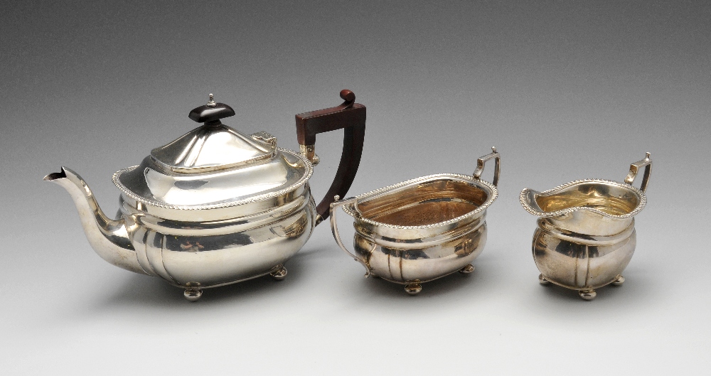 A modern silver three piece silver tea service, the oval bodies with lobed corners, gadrooned