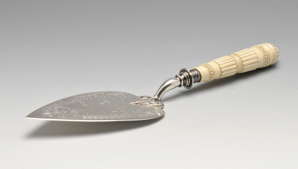 A late Victorian ivory handled silver trowel, having engraved and stippled foliate borders enclosing