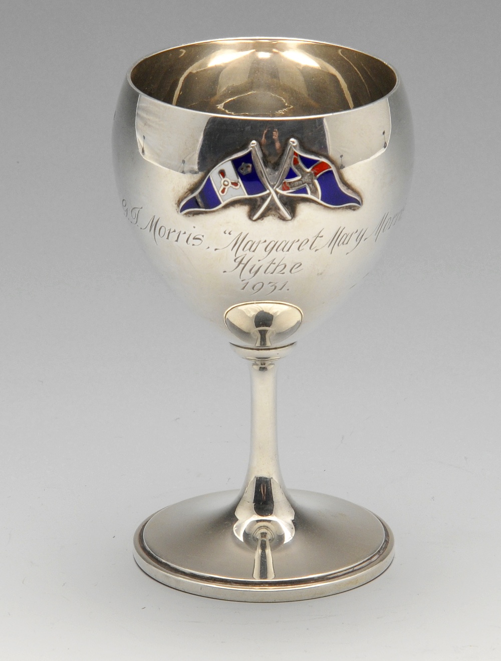 A 1930's small silver goblet of typical form, decorated with two raised enamel flags above a