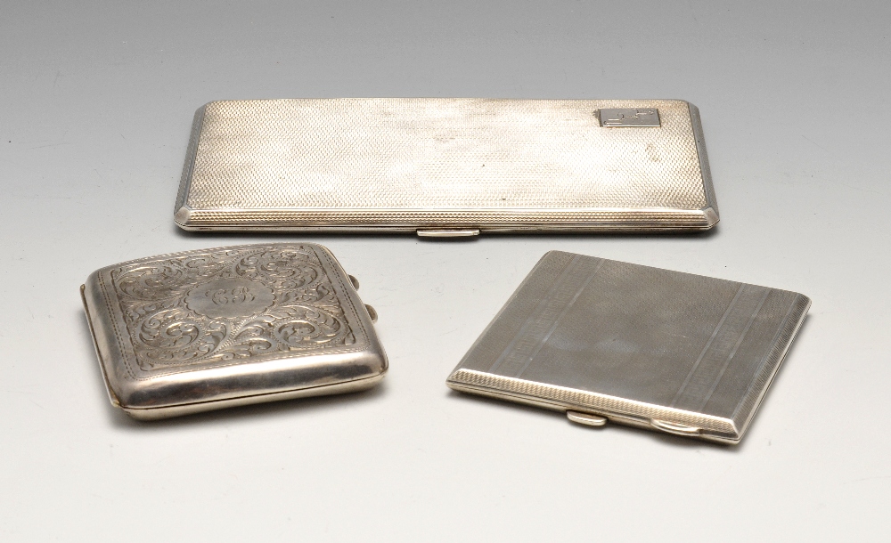 Three early twentieth century silver cigarette cases, comprising a large rectangular example