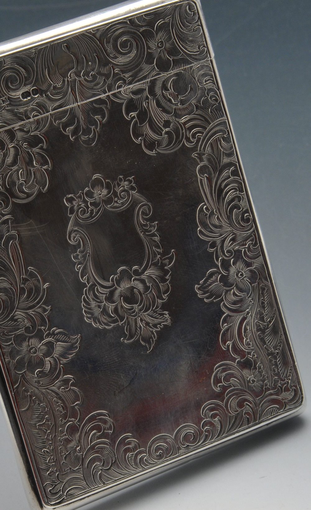 An early Victorian silver card case, the oblong form encased with floral scroll engraving and - Image 3 of 4