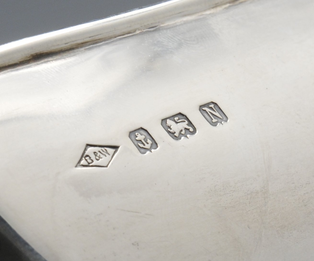 A 1930's four piece silver tea service, of plain chamfered form with angular handle and raised - Image 5 of 6