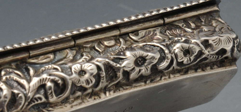 A late Victorian small silver box of oblong form, ornately embossed with floral and foliate - Image 6 of 8