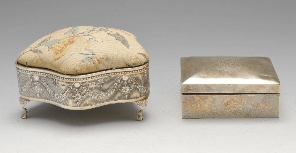 An early twentieth century silver mounted jewellery box, the shaped form embellished with floral