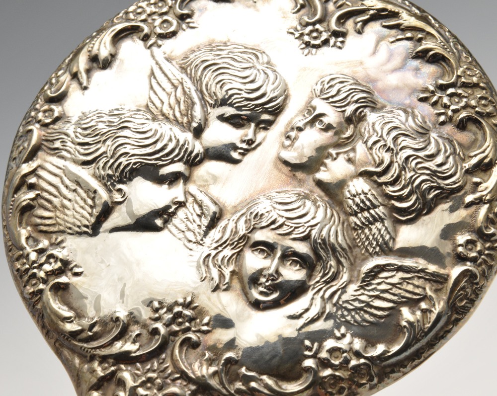 A 1970's silver mounted part dressing set having embossed cherub decoration within floral scrolls, - Image 3 of 8