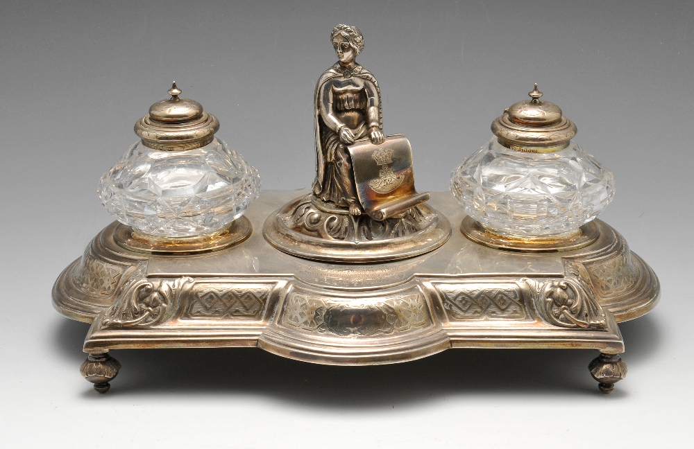 A mid-Victorian silver inkstand of shaped rectangular outline, decorated with a border of foliate