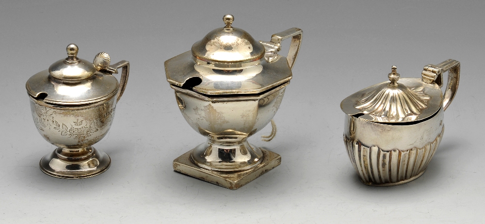 A late Victorian silver mustard pot of circular pedestal form with floral swag engraving and shell