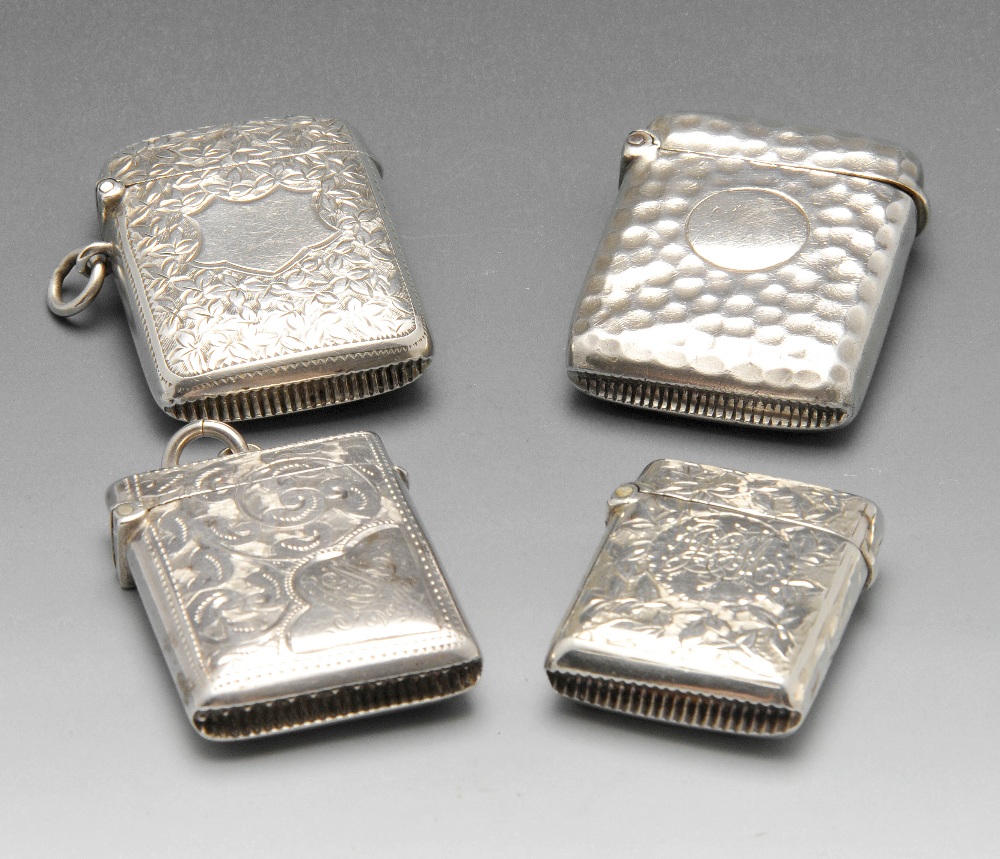 A late Victorian silver vesta case, engraved throughout with leaf patterns surrounding a vacant