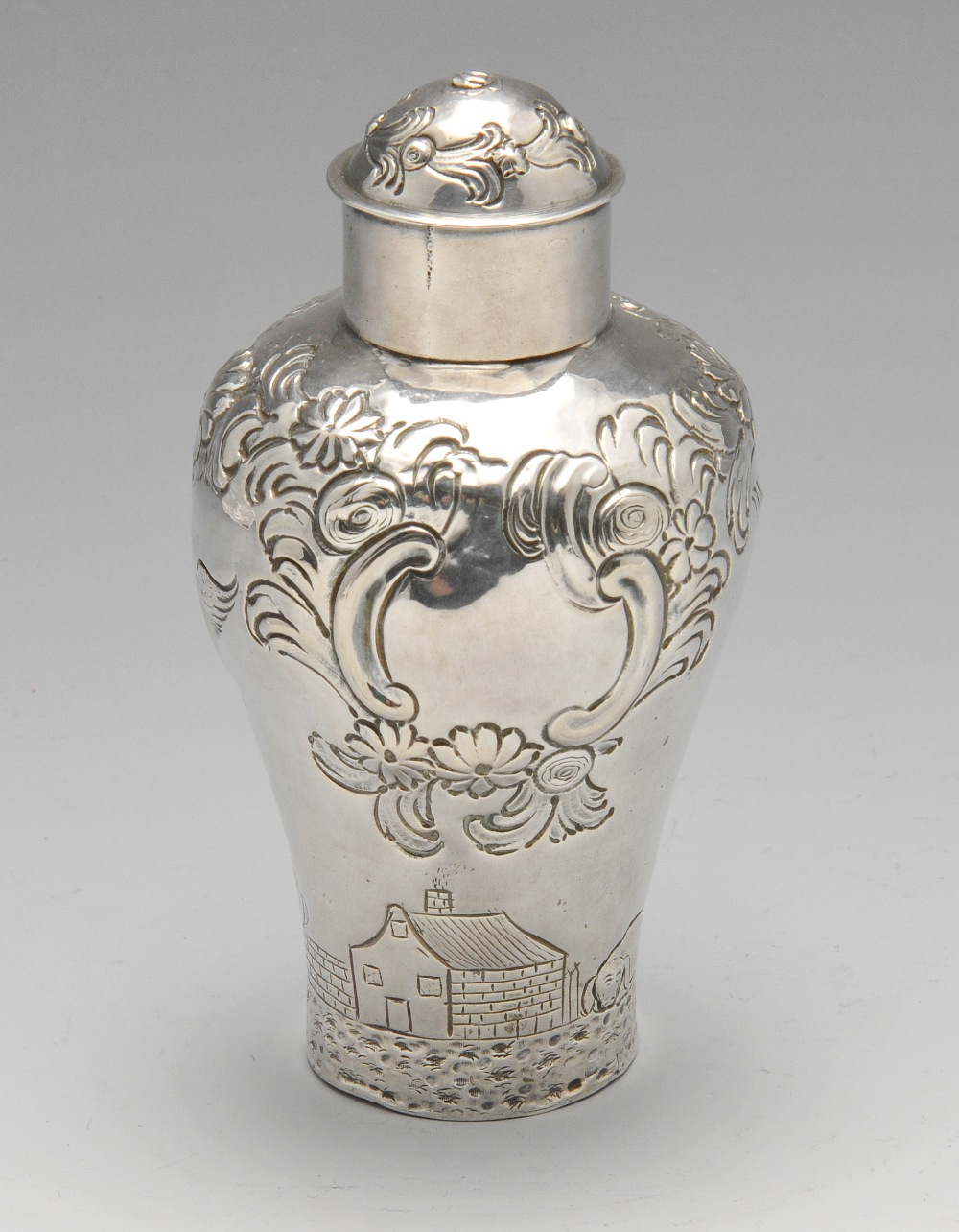 A George II silver tea caddy, the tapered body with bulbous shoulders, embossed and chased with a