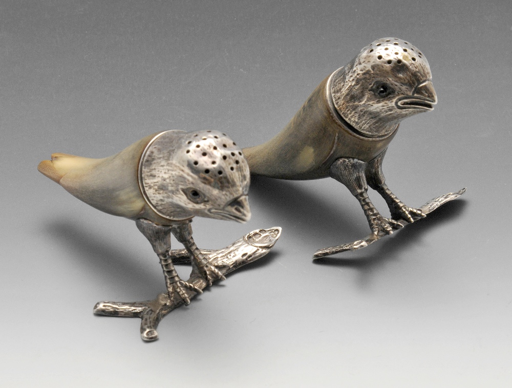 A pair of Victorian silver mounted horn peppers, each modelled as a bird perched on a branch.
