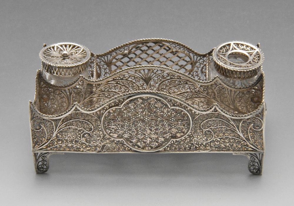 A continental small filigree inkstand, modelled in the style of a letter rack on four corner bracket