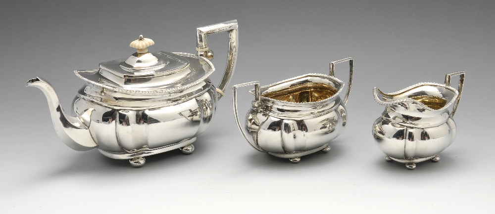 A late Victorian silver three piece tea service, comprising teapot, twin-handled sugar bowl and