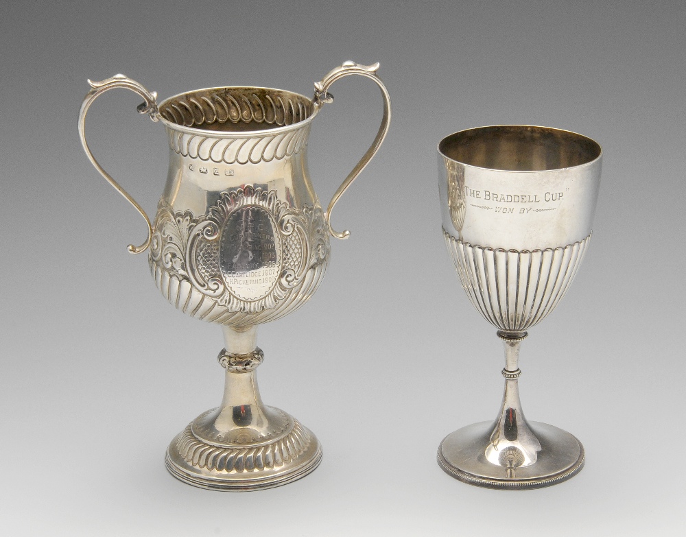 A late Victorian silver twin-handled trophy cup of baluster form and decorated with lobed borders