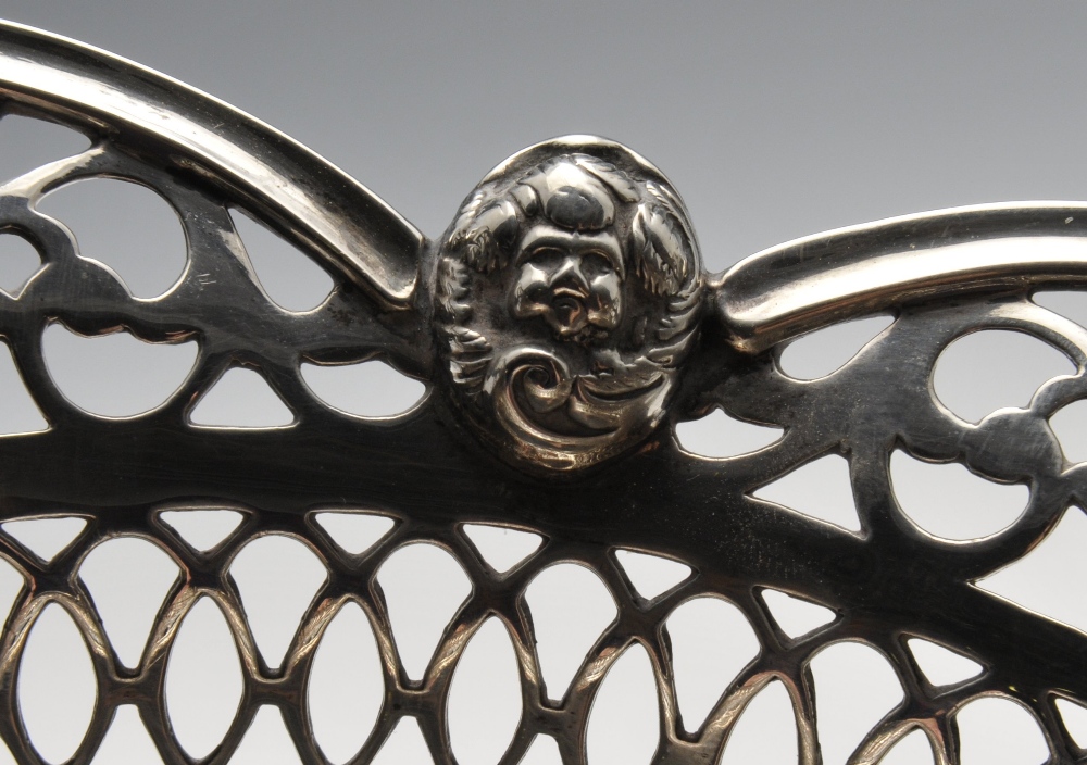 An Edwardian silver bread basket, the oval pierced openwork body with scroll and mask rim and raised - Image 3 of 5