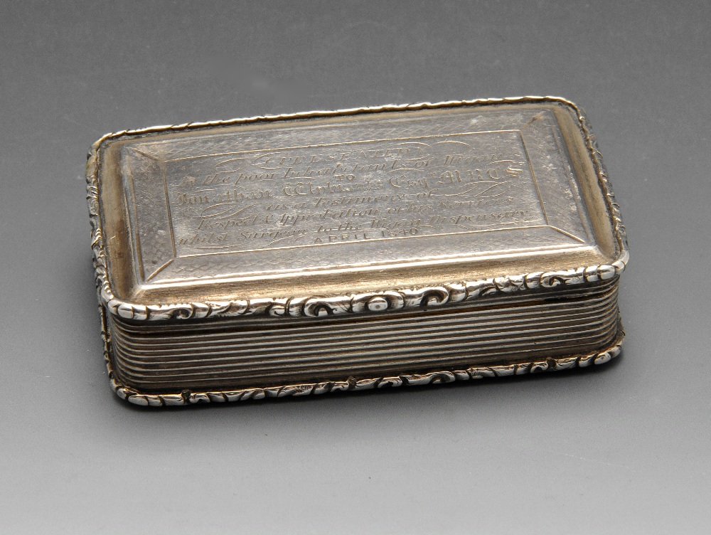 An early Victorian silver snuff box, the rounded rectangular form with floral scroll borders