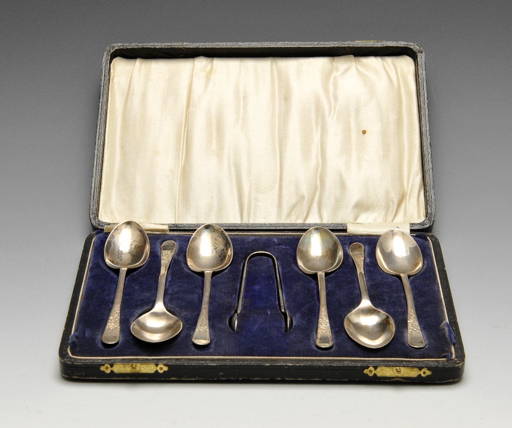 A cased set of six George V silver spoons and sugar tongs, each having floral engraving to the stem.