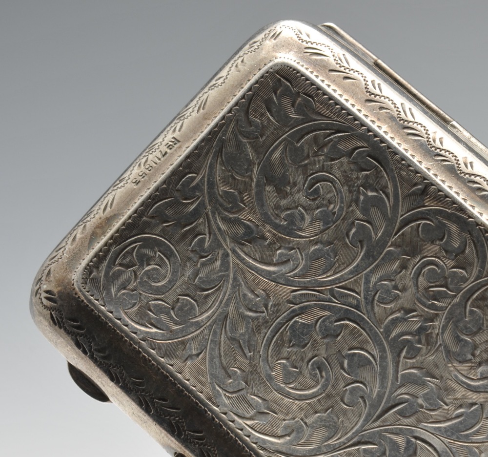 A 1920's silver cigarette case of rounded rectangular form, having foliate scroll engraving - Image 6 of 9