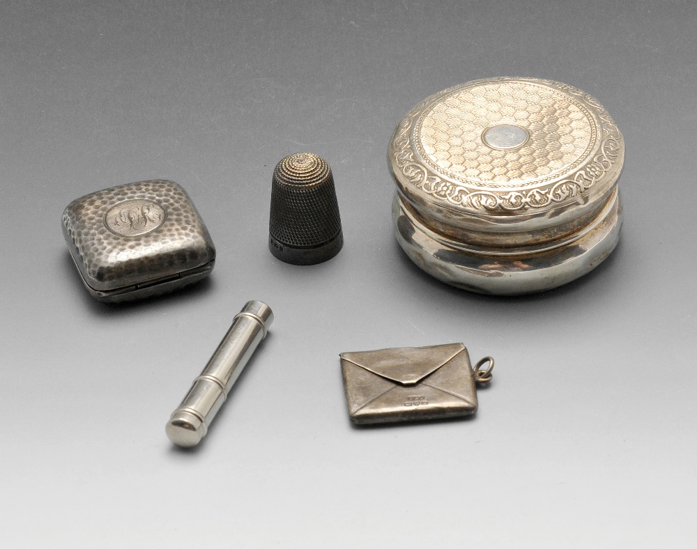 A small selection of mostly early twentieth century silver novelties, to include a small circular