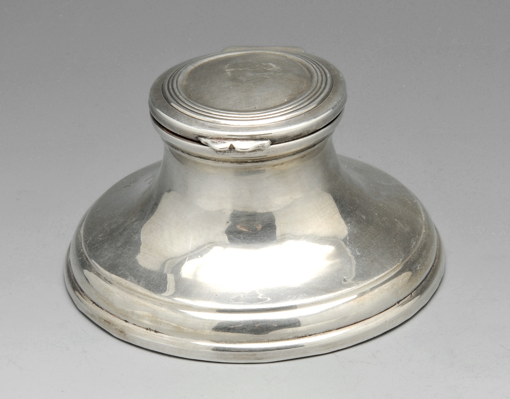 A 1920's silver inkwell of capstan form, the hinged and slightly domed cover with reeded border (