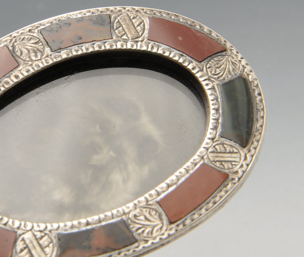 A late Victorian miniature silver photograph frame, the oval form inlaid with hardstones and - Image 4 of 4