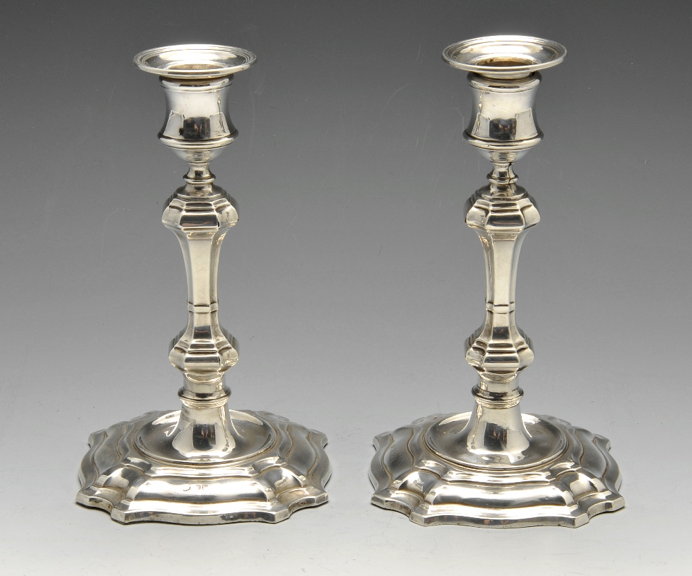 A pair of early twentieth century silver candlesticks in early Georgian style, each octagonal