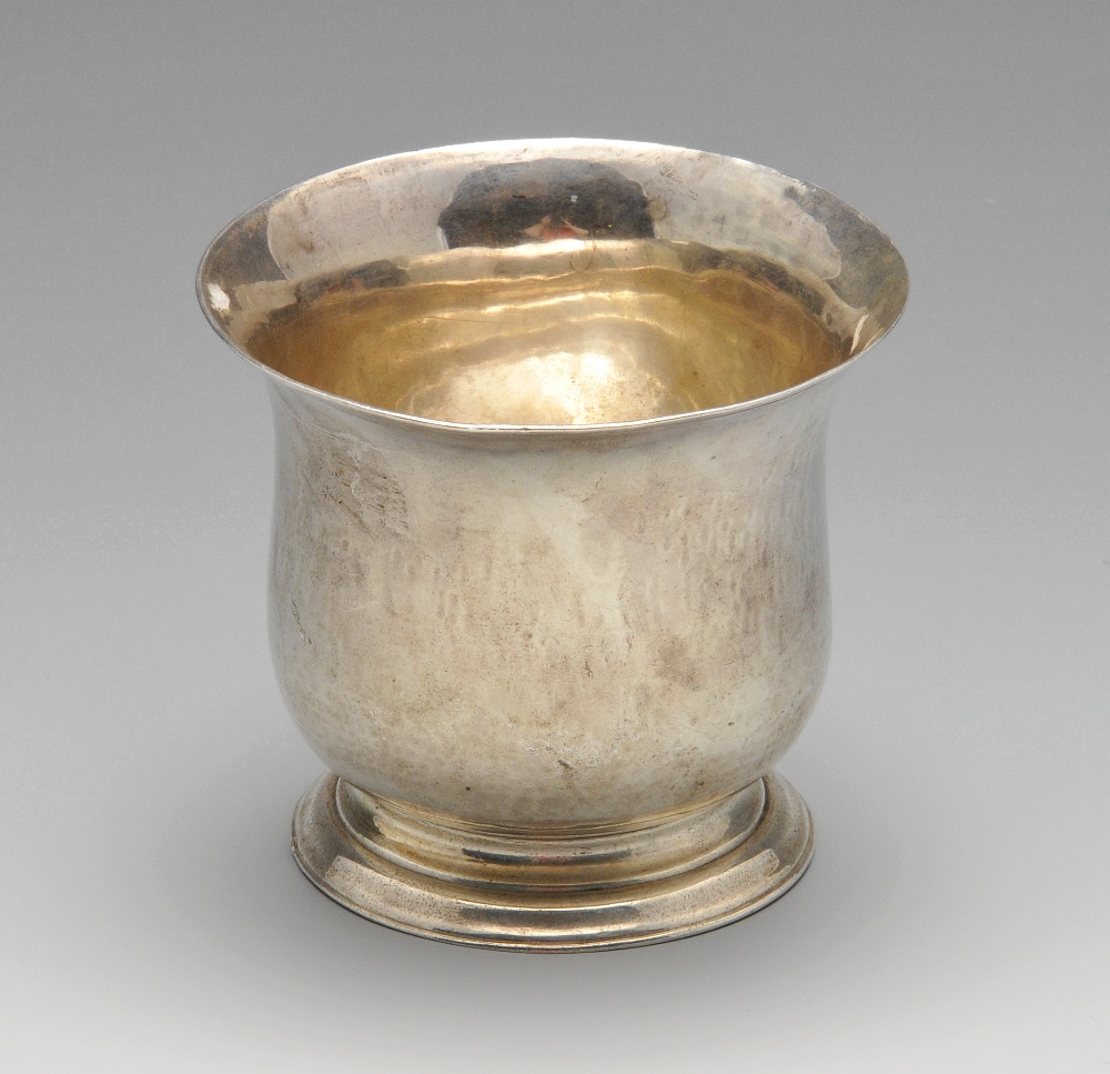 An early George III small silver bowl of plain baluster form to a skirted base and having a simple