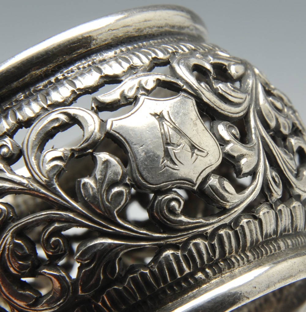 A set of three silver napkin rings of pierced circular form and decorated with stylised floral - Image 5 of 11