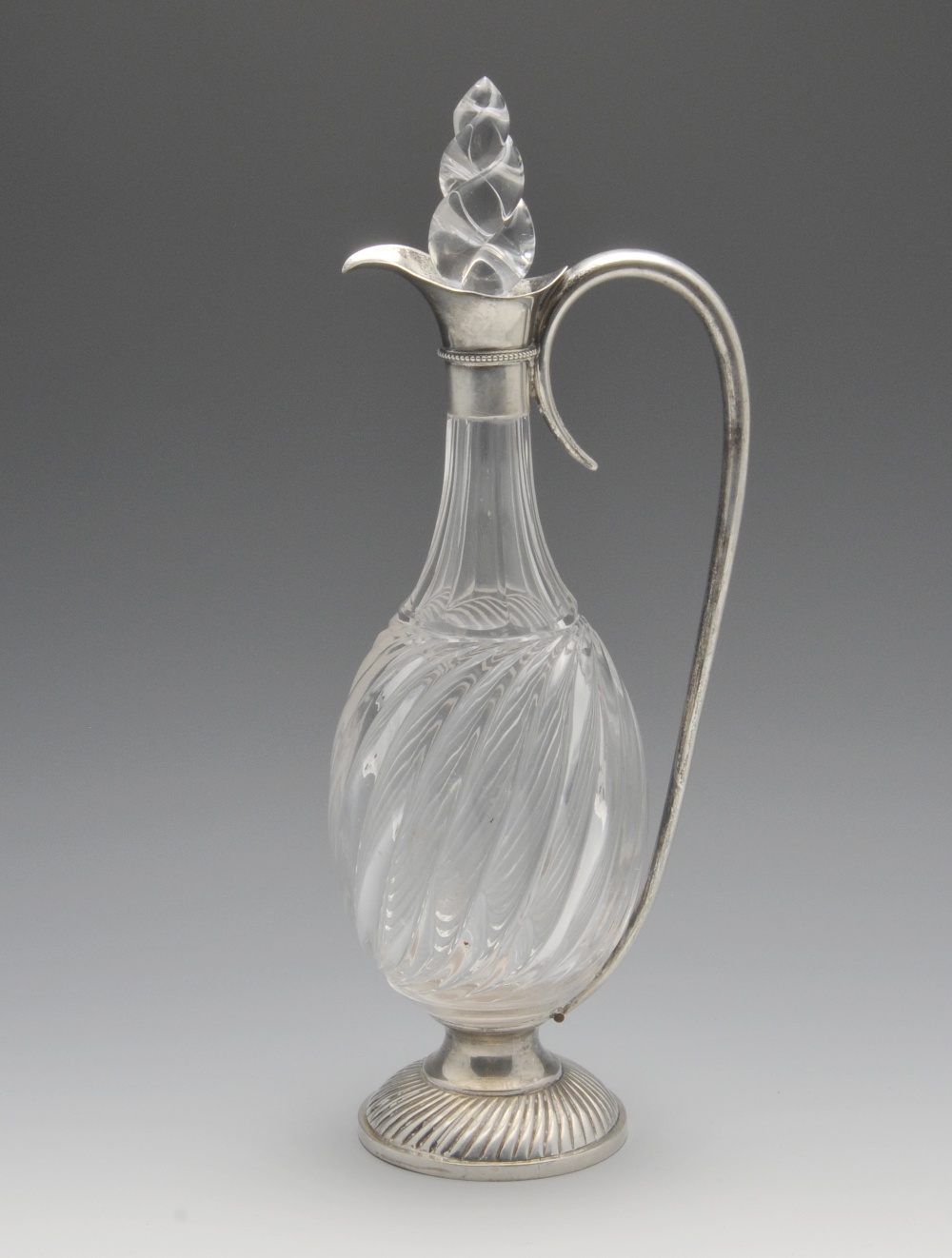 A Victorian silver mounted claret jug, the bulbous wrythen glass body and stopper with faceted