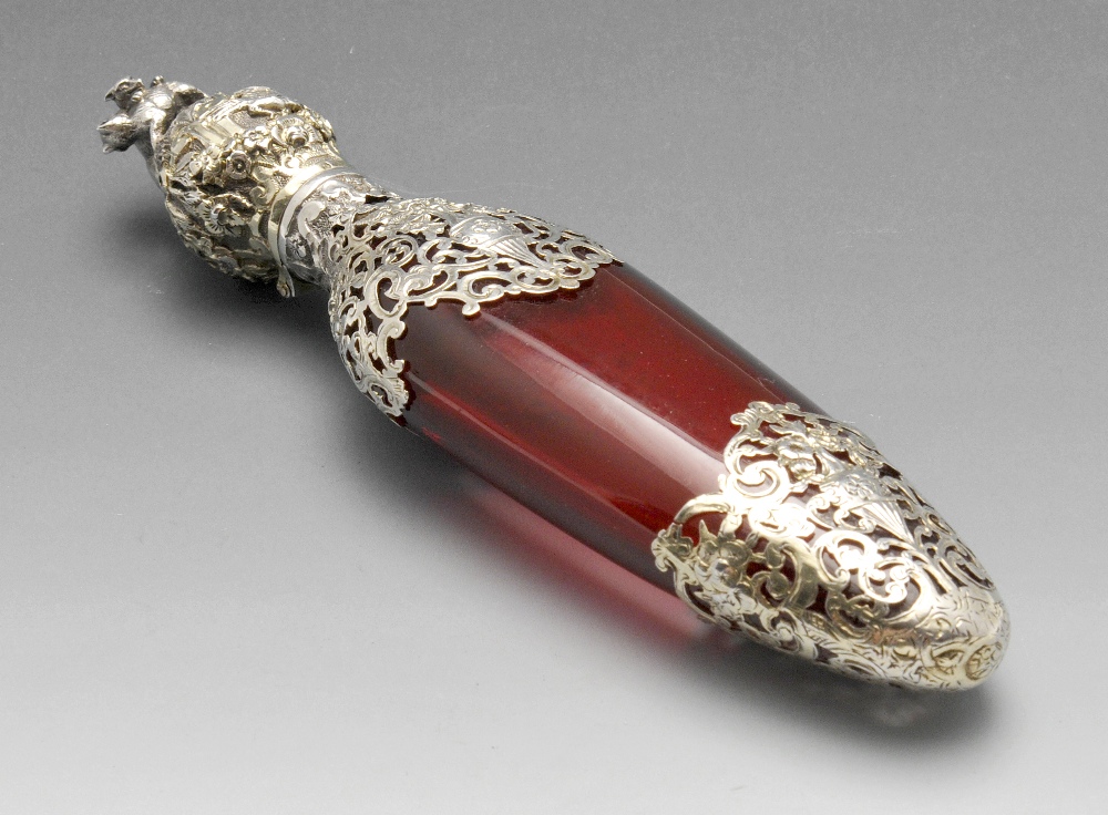 A French scent bottle, the cranberry glass body of tapered form and overlaid with scroll open-work