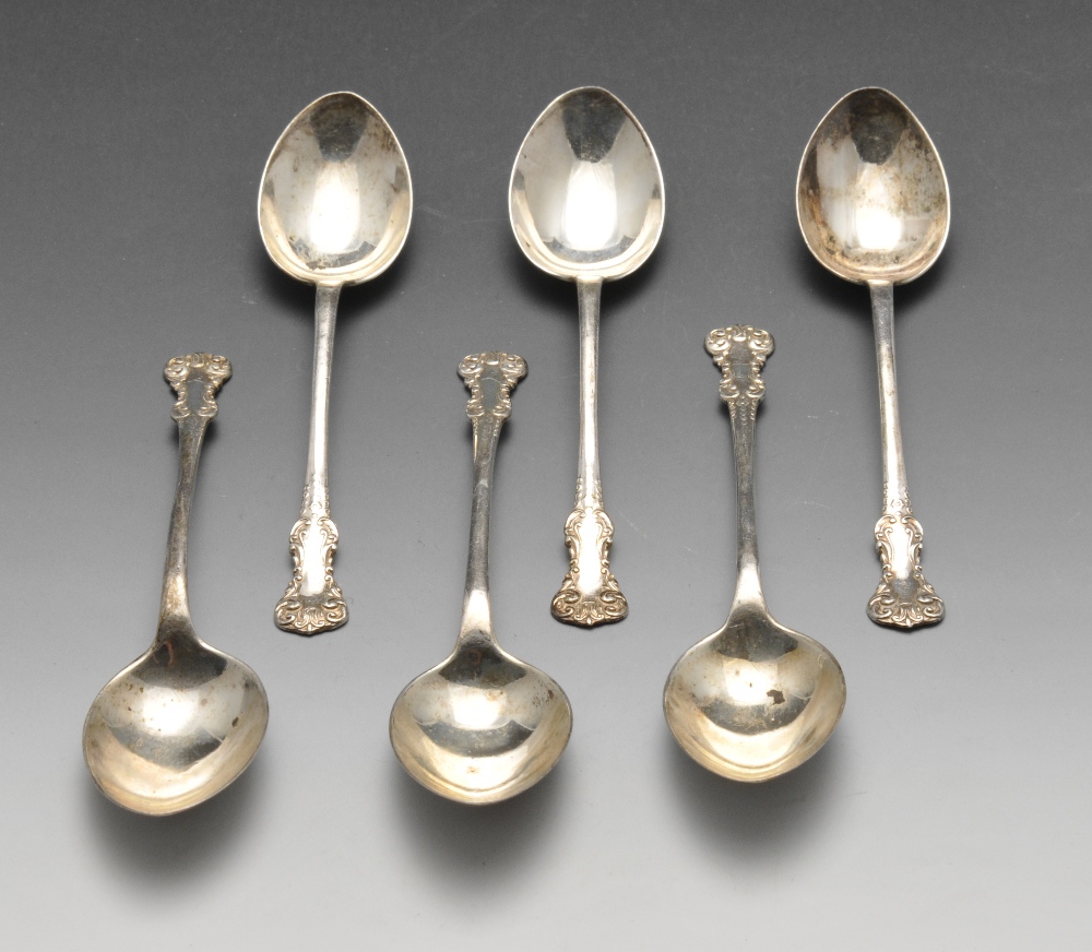 A set of six George V silver teaspoons having scrolling terminals leading to the plain stems,