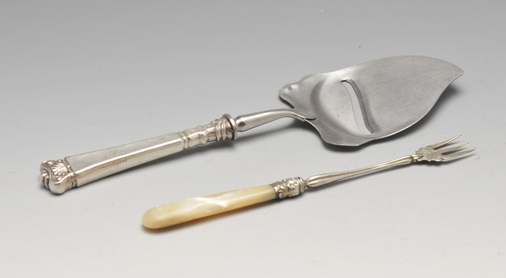 A Norwegian silver mounted cheese slice with tapered scroll embellished handle, marked Hestenes