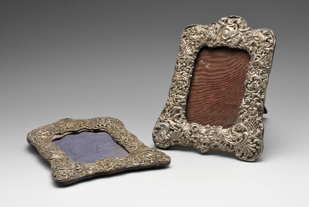 An Edwardian silver mounted photograph frame of shaped rectangular outline with easel back, ornately