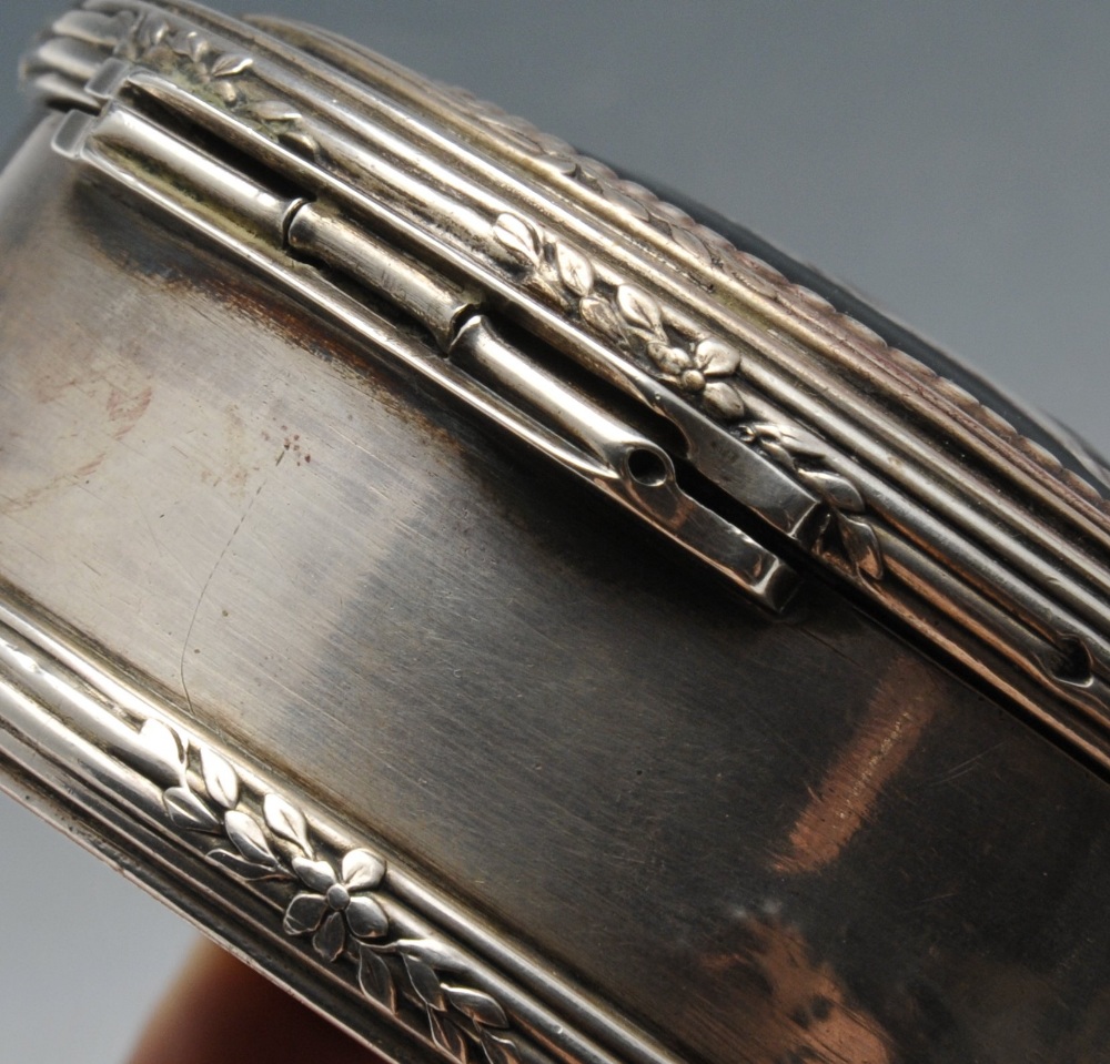 A French silver box of circular form with reeded borders and floral spray accents, the hinged - Image 4 of 5