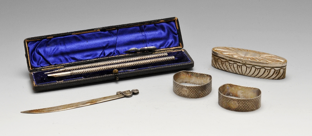 A small selection of mostly early 20th century silver items to include a pair of napkin rings, an