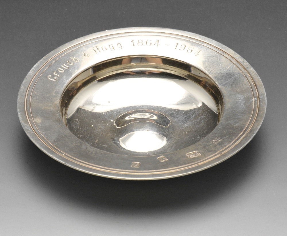 A small modern silver presentation dish, of circular outline having wide rim with personal