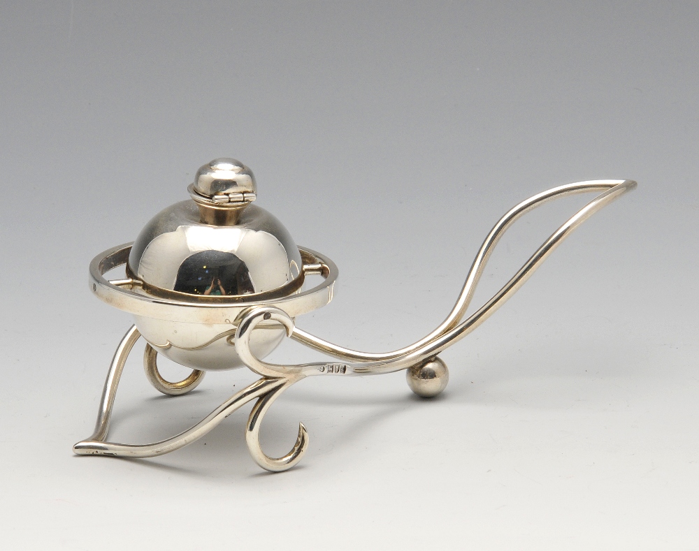 An Edwardian silver novelty table lighter, the central globe with domed, hinged lid and gimbal