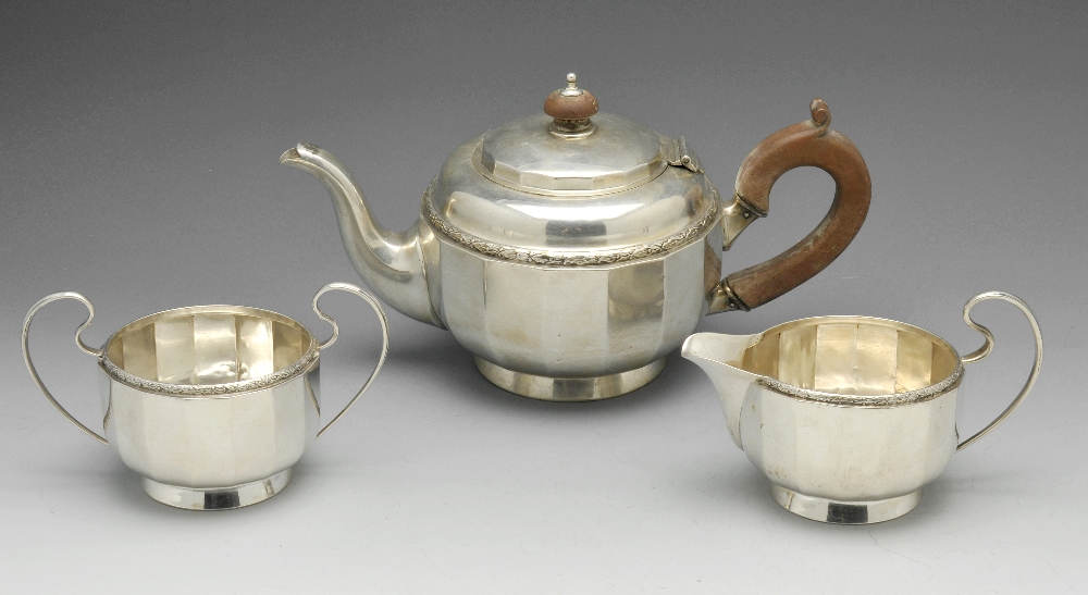 An early twentieth century silver three piece tea service, comprising teapot, milk jug and twin-