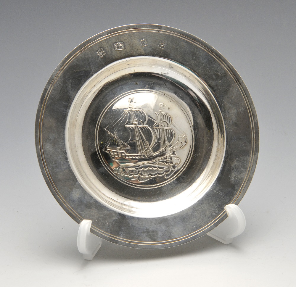 A modern silver Armada dish, the conventional form with central embossed depiction of a ship.