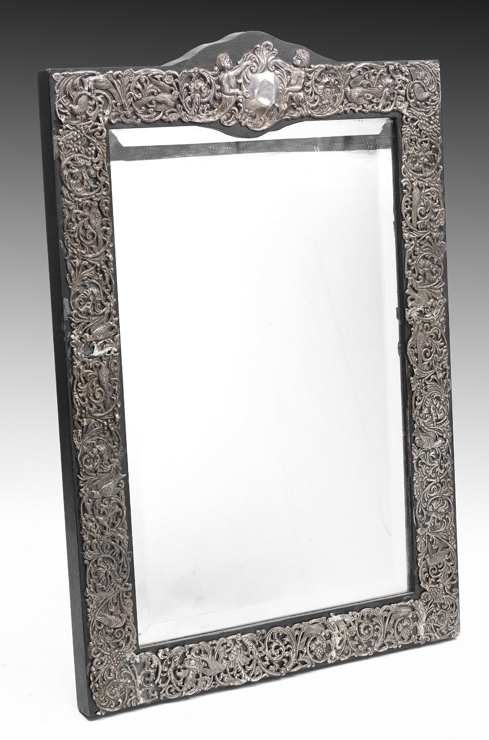 A large white metal fronted mirror, the rectangular shaped bevelled mirror, within a dark stained