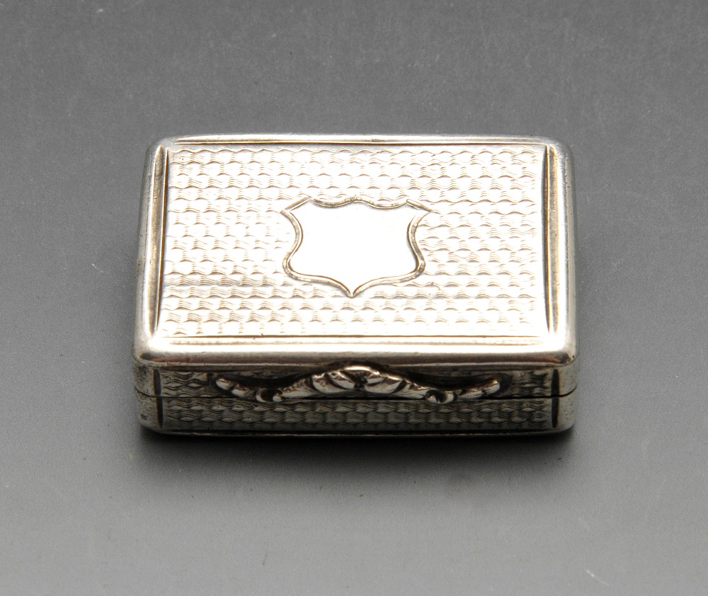 A Victorian silver vinaigrette, the oblong form with engine-turned decoration, vacant shield