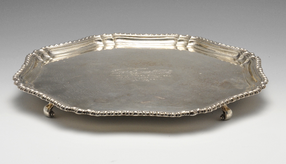 A 1930's silver salver of lobed octagonal outline, having gadrooned rim, a later central