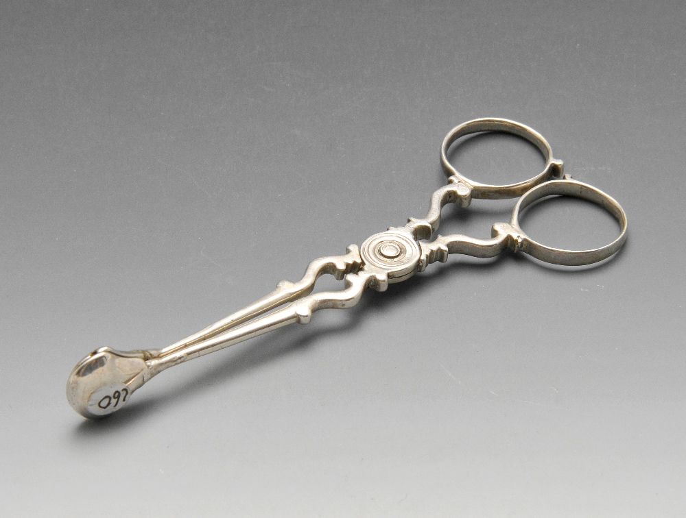 A pair of George III silver scissor action sugar tongs with scrolling body. Lion passant only