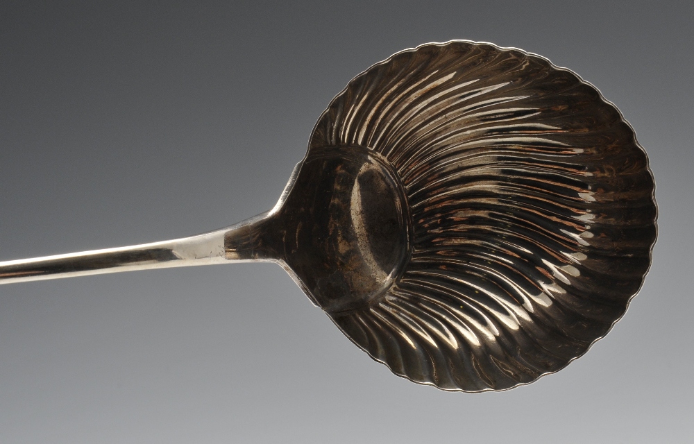 An early George III silver soup ladle with shell and scroll terminal and crest engraving to the - Image 5 of 6