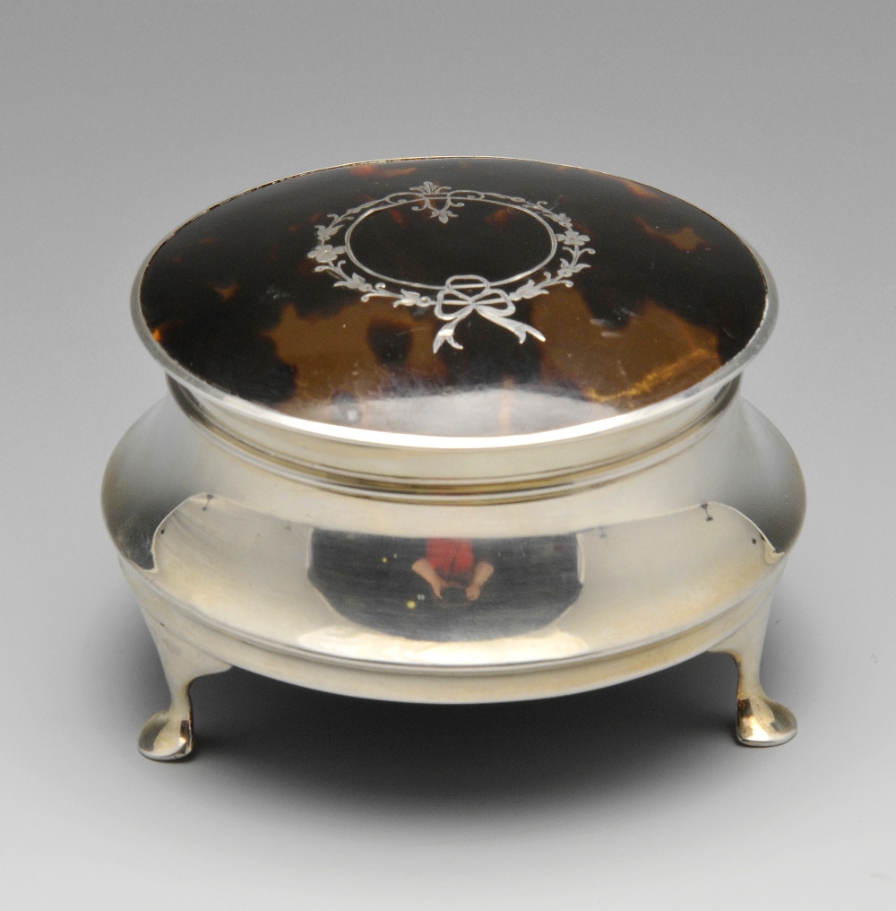 A 1920's silver tortoiseshell jewellery or trinket box, the circular capstan body with hinged