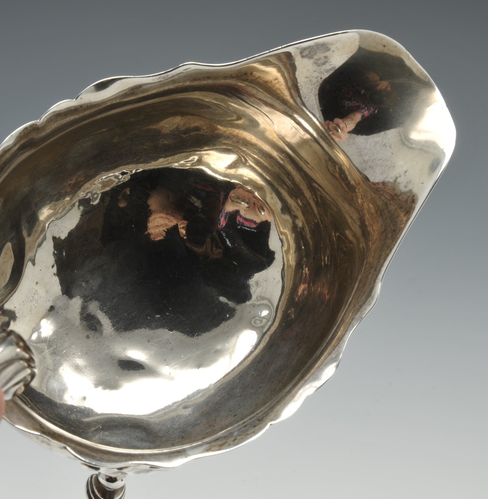 A pair of George II silver sauce boats, the oval bodies with scalloped rim, high arch leaf capped - Image 4 of 5