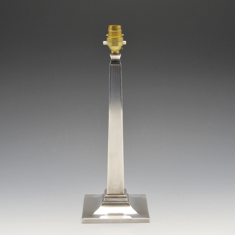 A 1930's silver mounted lamp base with filled square base rising to a tapering column and having