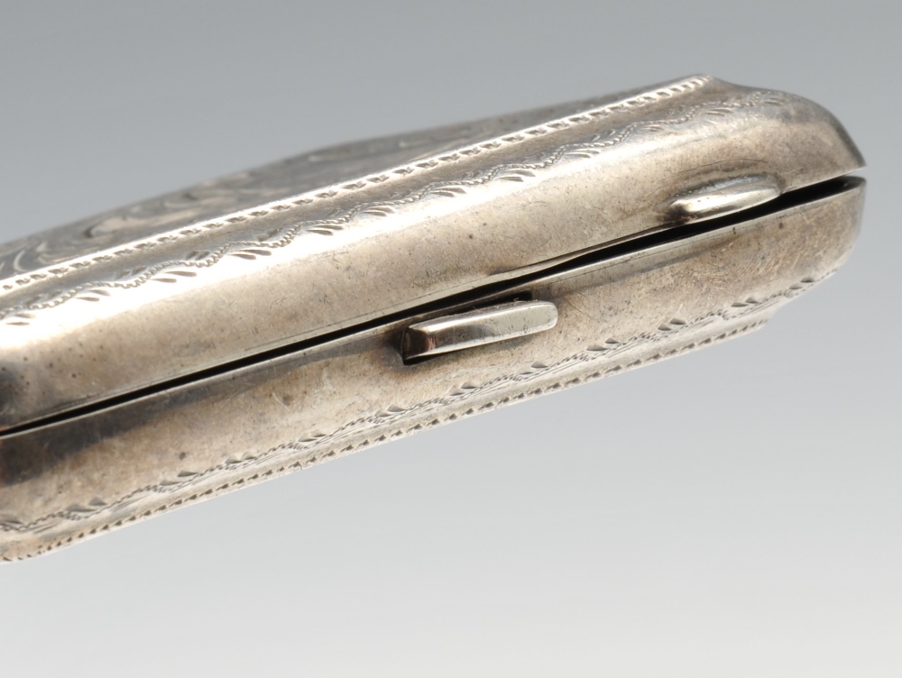 A 1920's silver cigarette case of rounded rectangular form, having foliate scroll engraving - Image 5 of 9
